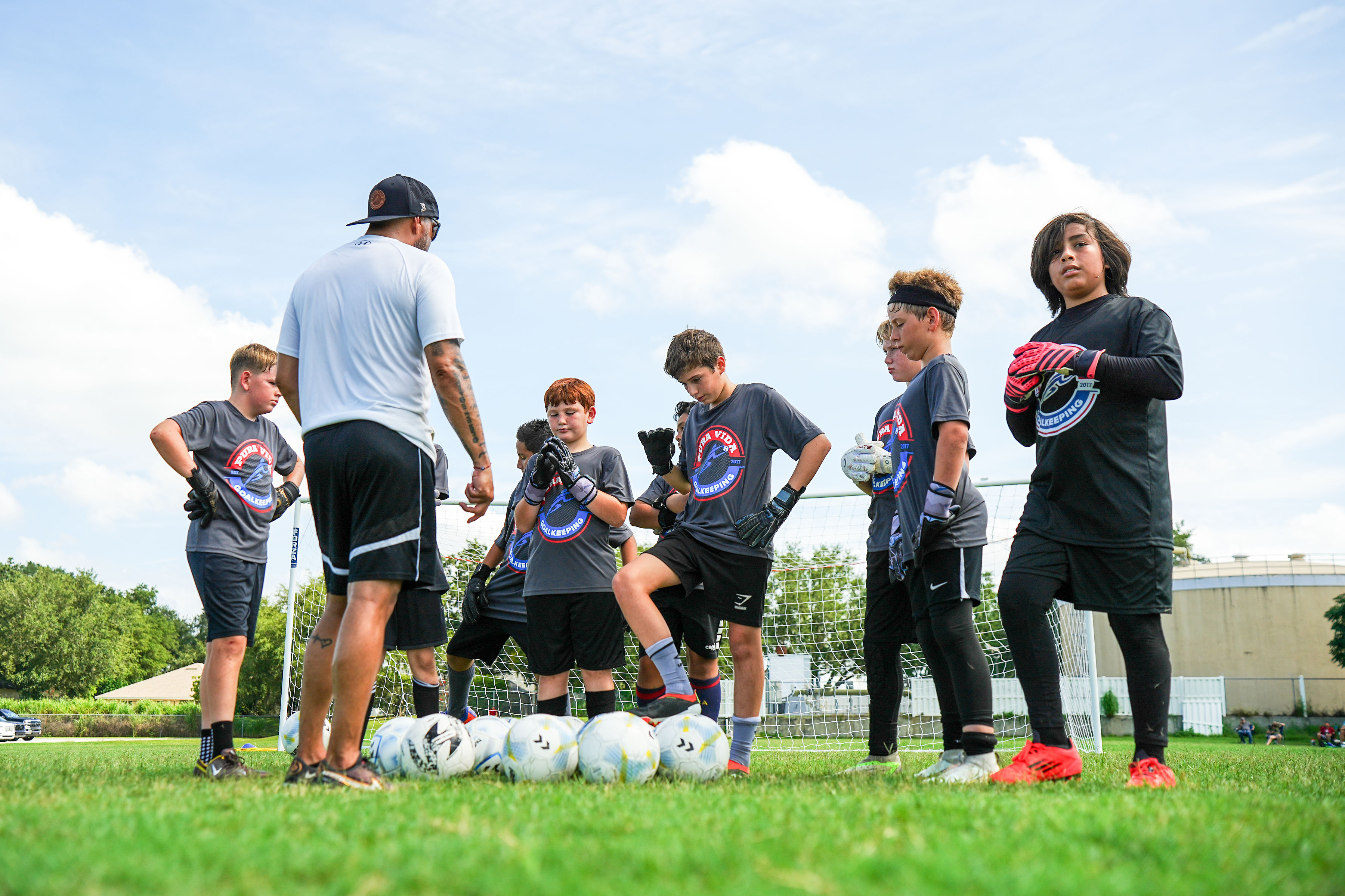 Coach and goalkeeper in training